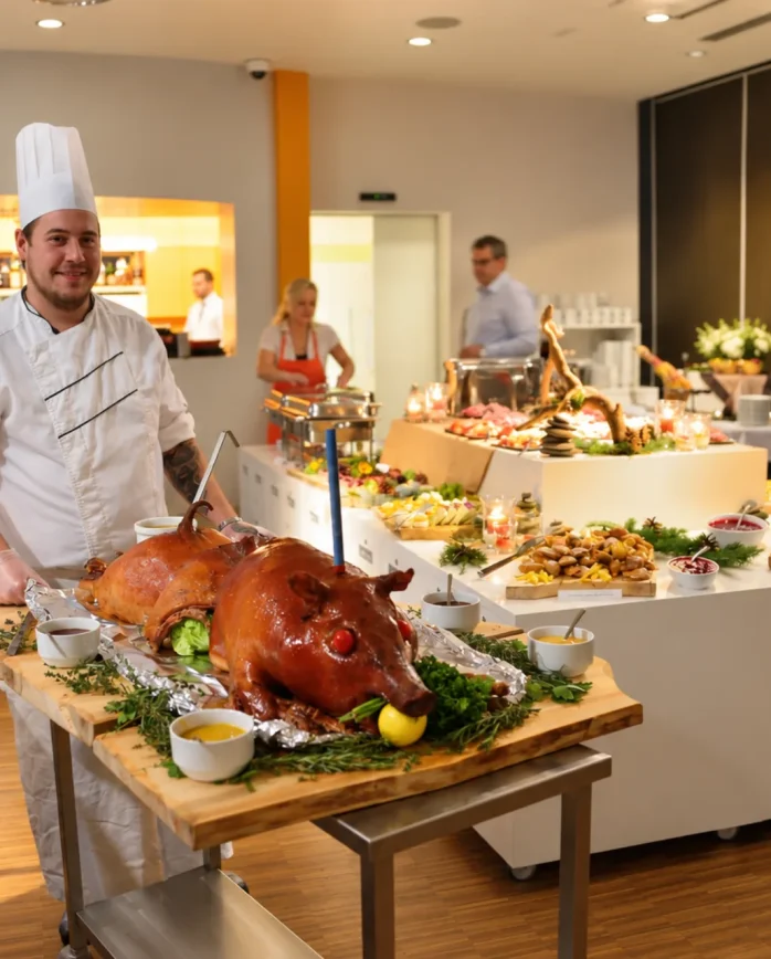 Kuchař Hotelu Antonie u slavnostního bufetu s pečeným seletem a výběrem pokrmů v hotelové restauraci.